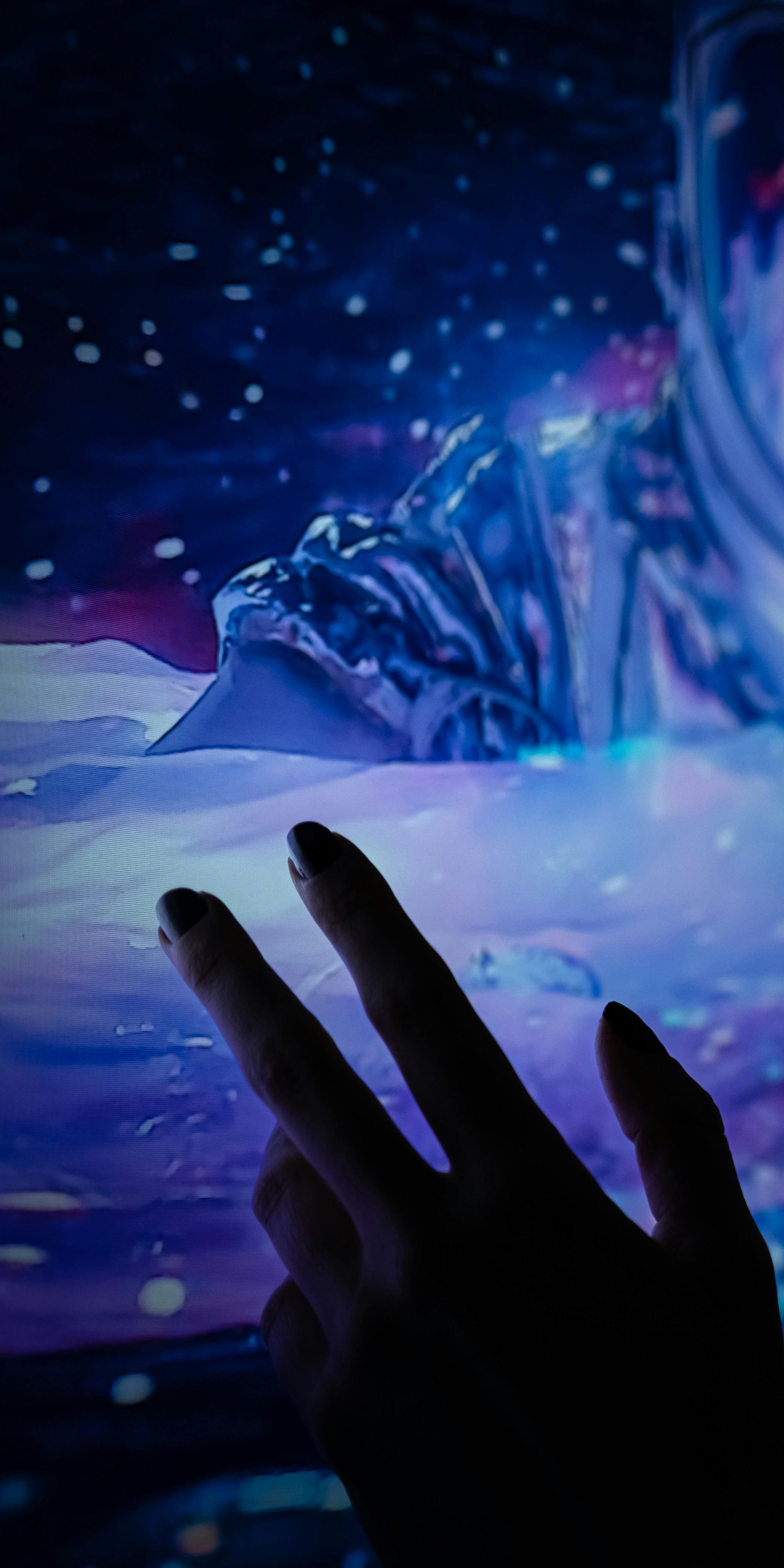 hand reaching into the galaxy 