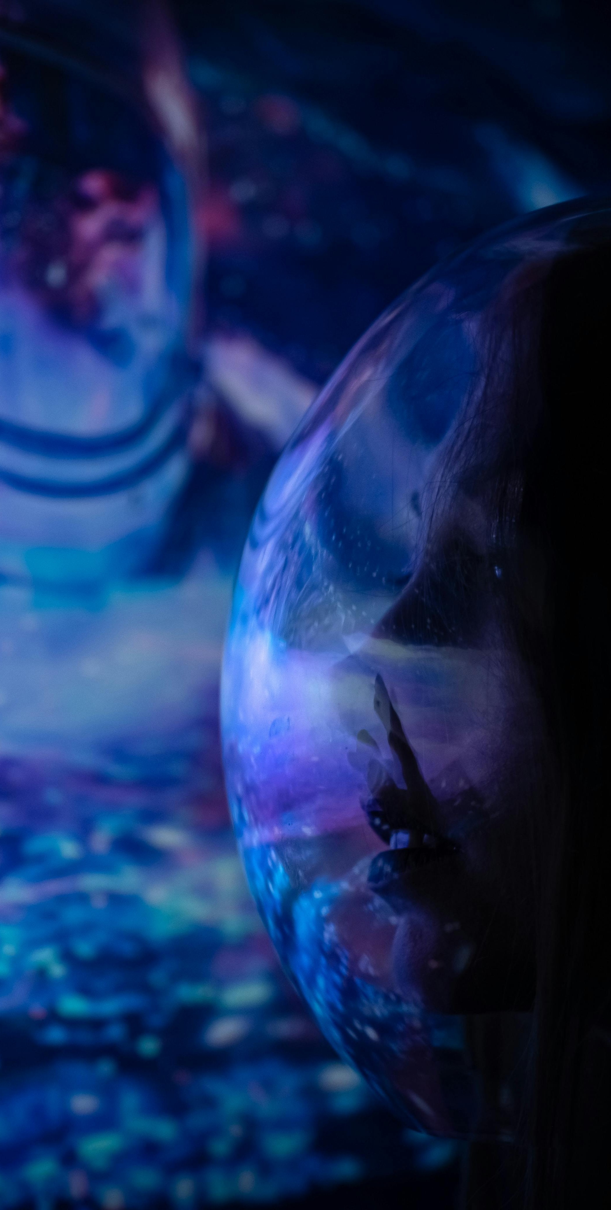 helmet reflecting an astronaut and galaxy